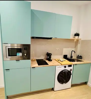 a kitchen with blue cabinets and a microwave at Loft Sofia a estrenar con luz natural en corazon de Valencia in Valencia