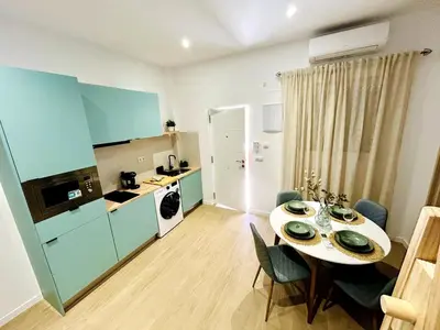 a kitchen and dining room with a table and chairs at Loft Sofia a estrenar con luz natural en corazon de Valencia in Valencia