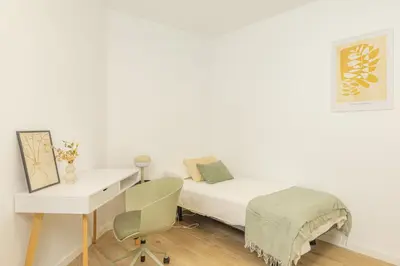 a white bedroom with a bed and a desk at VL - Carrer de Berni i Catala in Valencia