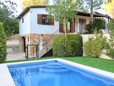 a house with a swimming pool in front of a house at Casa Playamonte in Navarrés