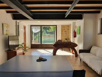 a living room with a table and a piano at Casa Playamonte in Navarrés