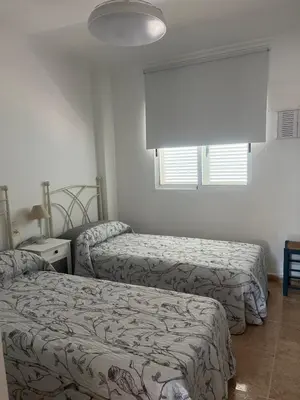 a bedroom with two beds and a window at Apartamento en Canet Berenguer Valencia in Canet de Berenguer