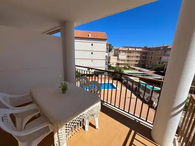 a balcony with a table and a view of a pool at Apartamento en Canet Berenguer Valencia in Canet de Berenguer