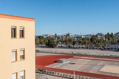 a building with a basketball court next to a building at Invalencia - Begis Flat Cabanyal in Valencia