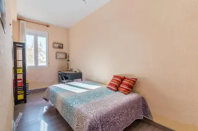 a small bedroom with a bed and a window at Invalencia - Begis Flat Cabanyal in Valencia