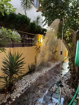 a garden with a green shower in a yard at Oceanfront Ideal for couples and teleworking in Moncófar