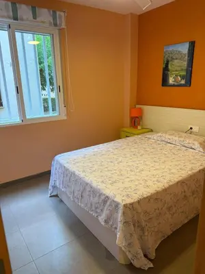 a bedroom with a bed and a window at Oceanfront Ideal for couples and teleworking in Moncófar