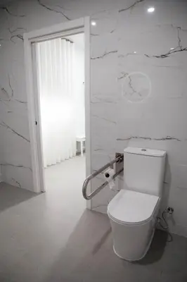a bathroom with a white toilet in a room at M&A Hostal en Onda in Bechí