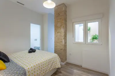 a bedroom with a bed and a window at Apartment Ruzafa Tomasos in Valencia