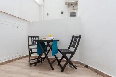 two chairs and a table in a room at Apartment Ruzafa Tomasos in Valencia