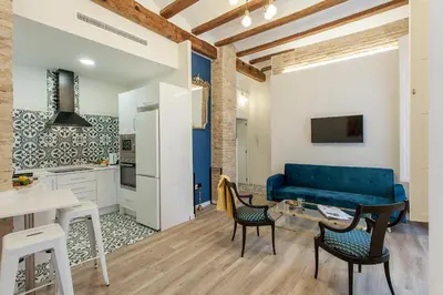 a living room with a blue couch and a table at Apartment Ruzafa Tomasos in Valencia