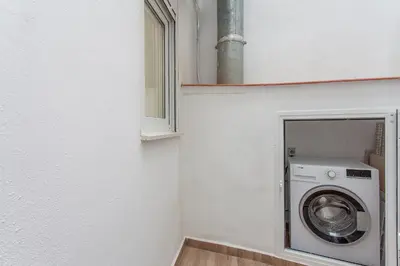 a washing machine in a room with a window at Apartment Ruzafa Tomasos in Valencia
