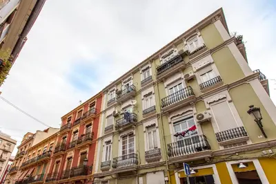 a tall building with balconies on a city street at Apartment Ruzafa Tomasos in Valencia