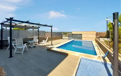a patio with a swimming pool on top of a building at Awesome Home In Turis in Turís