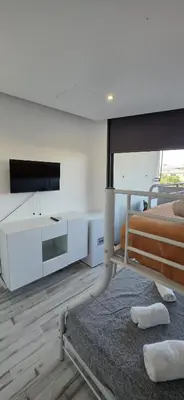 a white room with a bed and a tv at Mi Huésped 130 Valencia, Aeropuerto Manises in Manises