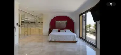 a bedroom with a bed and a large window at Torrent Veda Chalet in Torrent