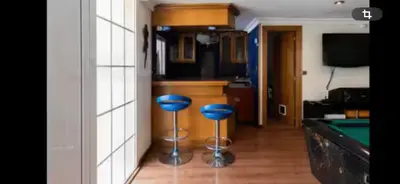 a room with a pool table and two blue stools at Torrent Veda Chalet in Torrent