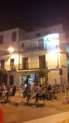a group of people sitting in chairs in front of a building at Casa Rural 
