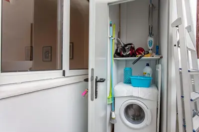 a washing machine in a bathroom next to a window at Apartment with terrace in Extramurs in Valencia