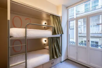 two bunk beds in a room with a sign at Camila Hostel Valencia in Valencia