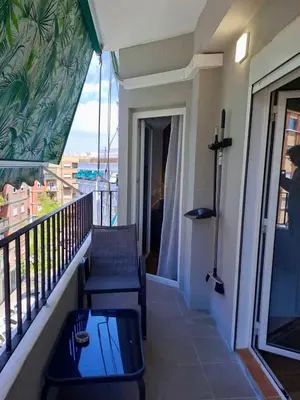 a balcony with a chair and a table on a balcony at Amazing bright and recently remodeled apartment in Valencia