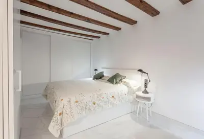 a white bedroom with a bed and a table at Valencia Flat Rental City center town hall in Valencia