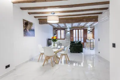 a dining room with white walls and a table and chairs at Valencia Flat Rental City center town hall in Valencia