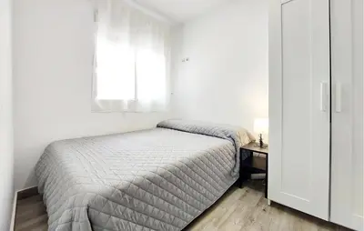 a white bedroom with a bed and a window at Amazing Home In Turís in Turís