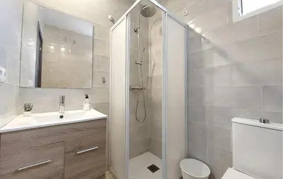 a bathroom with a shower and a toilet and a sink at Amazing Home In Turís in Turís