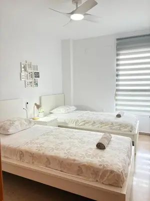 a bedroom with two beds and a ceiling fan at UIM Mediterraneo Alpuente Wifi in Puerto de Sagunto