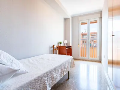 a bedroom with a bed and a desk and a window at Apartment Playa Patacona by Interhome in Valencia