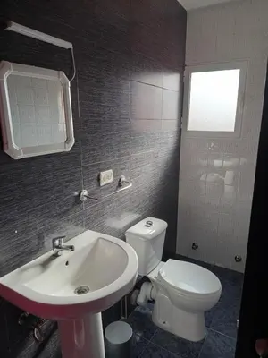 a bathroom with a white toilet and a sink at Casa la Abuela in Siete Aguas