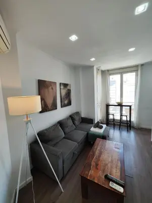 a living room with a couch and a table at Apartment Market Ruzafa 10B in Valencia