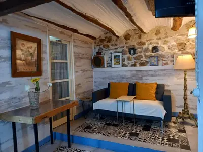 a living room with a couch and a table at Casa Rural La Rocha in Chulilla