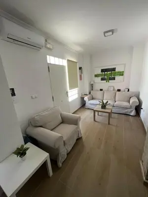 a living room with two couches and two tables at Estupendo apartamento en Llíria in Lliria