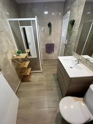 a bathroom with a sink and a toilet and a mirror at Estupendo apartamento en Llíria in Lliria