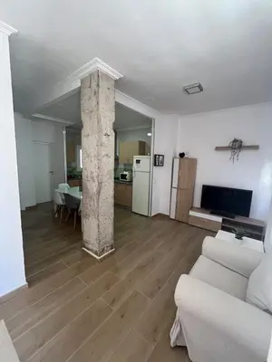 a living room with a couch and a table at Estupendo apartamento en Llíria in Lliria
