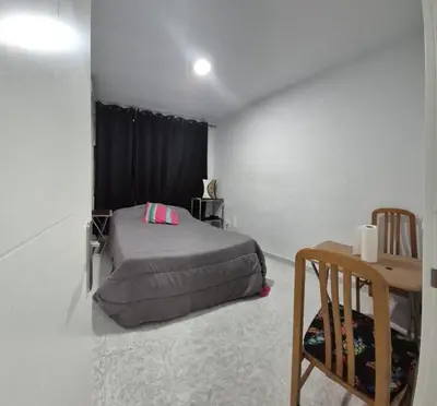 a bedroom with a bed and a table in it at Valencia Centro 3 compartido in Valencia