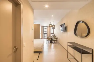 a hotel room with a bed and a mirror at Housing Maritim by SharingCo in Valencia