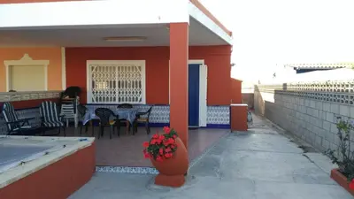 a patio with a table and chairs on a house at Ca Erik in Mareny Barraquetas