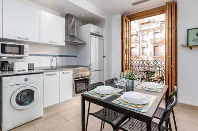 a kitchen and dining room with a table and chairs at VLC Host - Poeta Llombart in Valencia