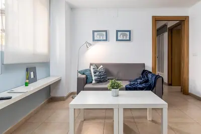 a living room with a couch and a table at VLC Host - Poeta Llombart in Valencia