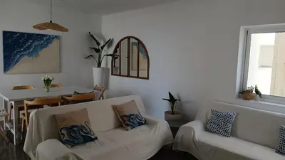 a living room with two white couches and a table at El Faro de Nules in Mascarell