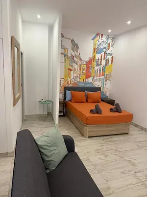 a bedroom with a bed and a couch in it at Loft Boutique 2 next to Torres de Serrano in Valencia
