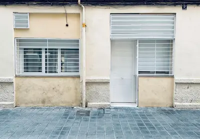 two white garage doors on a building at Loft Boutique 2 next to Torres de Serrano in Valencia