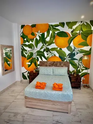 a bedroom with a mural of oranges on the wall at Boutique Loft 1 next to Torres de Serrano in Valencia