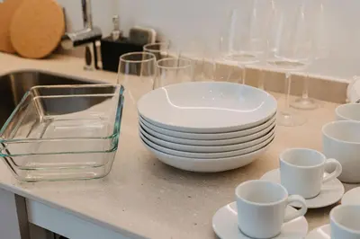 a counter top with plates and cups and glasses at Exclusivo loft 3 en zona privilegiada en Valencia in Valencia