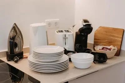 a pile of plates and bowls on a kitchen counter at Exclusivo loft 3 en zona privilegiada en Valencia in Valencia