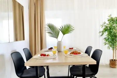 a table with a tray of bread and fruit on it at Apartment with sea view in Cullera in Faro de Cullera