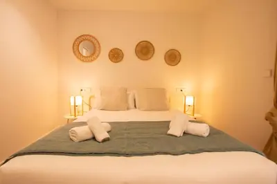 a bedroom with a large bed with three pillows at Apartamento Familiar En Valencia Centro - Plaza Ayuntamiento in Valencia